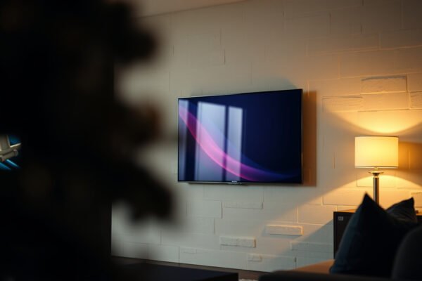 Comparison of QLED TVs in a bedroom and living room setting for optimal viewing experience.