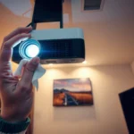 A person troubleshooting common home projector problems with tools and manuals.